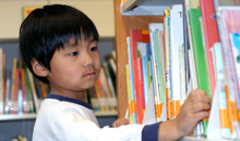 Photo of a young child with books